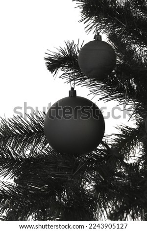 Black baubles on a black Christmas tree isolated over white background