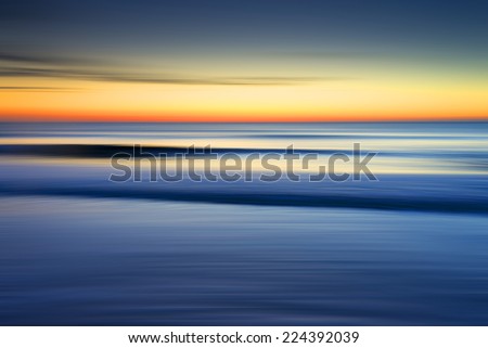 Sunrise at the beach with ICM (intentional camera move) achieved by panning the camera and blurring the image to give abstract seascape