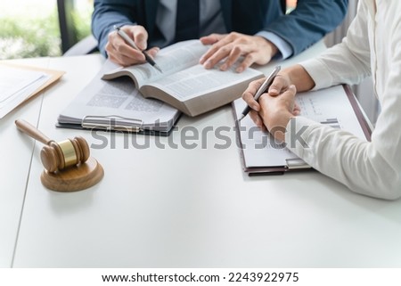 Lawyer Legal counsel presents to the client a signed contract with gavel and legal law. justice and lawyer Business partnership meeting Royalty-Free Stock Photo #2243922975