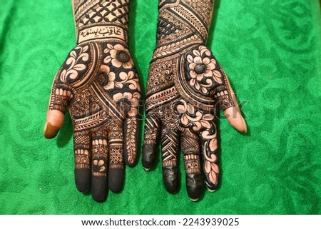 Close-up Short Of Two Mehndi Hands Of Bride  Royalty-Free Stock Photo #2243939025