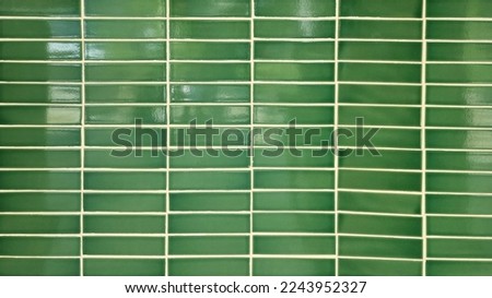 close up green mosaic wall tiles in tropical style. real antique ceramic interior wall tiles. wall tiles background for modern, simple, bold, fresh, soft, earth tone concept.