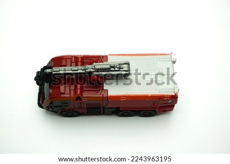 red color toy car in the shape of a fire engine isolated on a white background