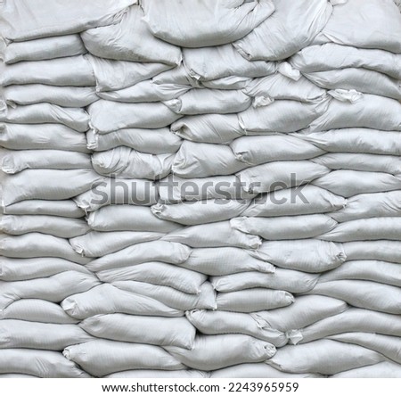 Texture of barricade wall made of white sandbags for war purposes. Defense concept background bags to strengthen the defensive structure during the battle. Protection in time of war.