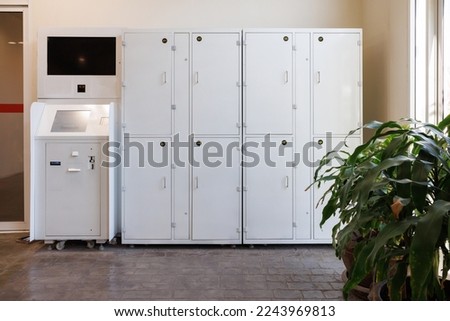 white smart locker for traveller. electronic steel parcel locker, automatic mailboxes. Royalty-Free Stock Photo #2243969813