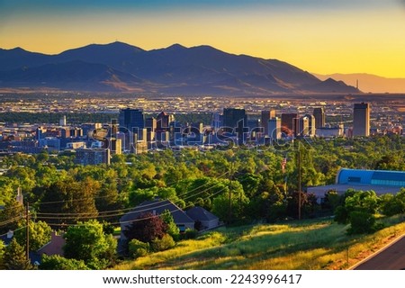 Salt Lake City skyline at sunset with Wasatch Mountains in the background, Utah, USA. Royalty-Free Stock Photo #2243996417