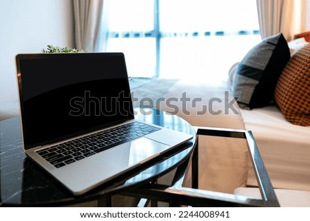 notebook computer set on the table in front of the sofa