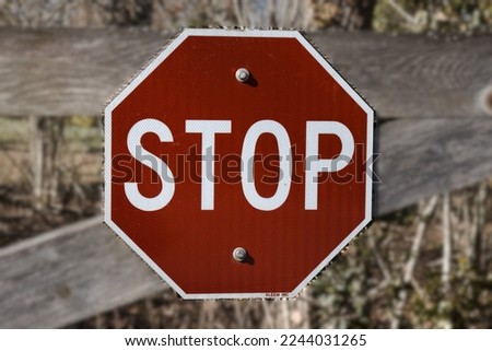 Stop Sign on Wooden Gate