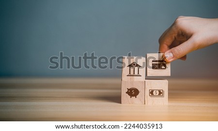Hand arranging wood block stacking with icon online transaction, credit card payment, banking, cash. Finance technology (FINTECH) concept