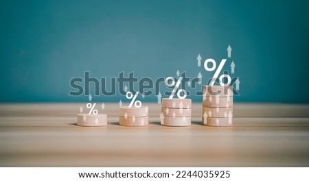 Interest rate financial and mortgage rates concept. Wooden block increasing on top with percentage symbol and arrow upward direction. Return on stocks and mutual funds from business growth concept.