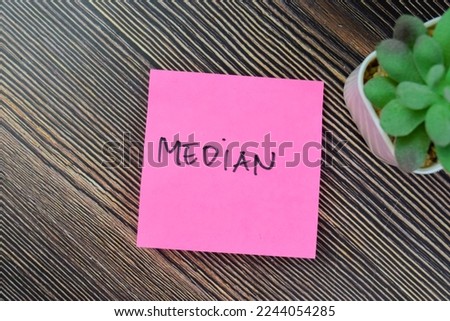 Concept of Median write on sticky notes isolated on Wooden Table. Royalty-Free Stock Photo #2244054285
