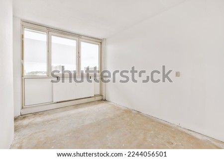 an empty room with white walls and no one person standing in the photo is taken to the right, it's very clean