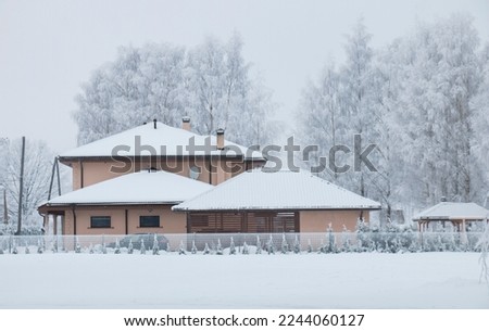 winter landscape, beautiful dwelling house covered with hoarfrost on a winter frosty day