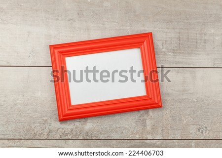 Red photo frame on wood table 