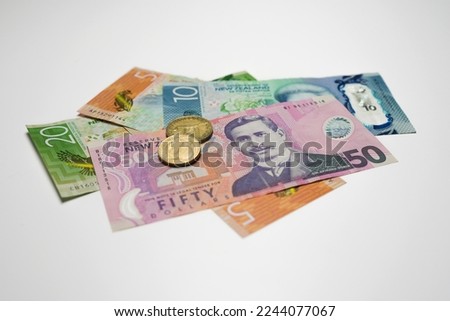 Pile of New Zealand dollars and  coins  in detail on white Royalty-Free Stock Photo #2244077067