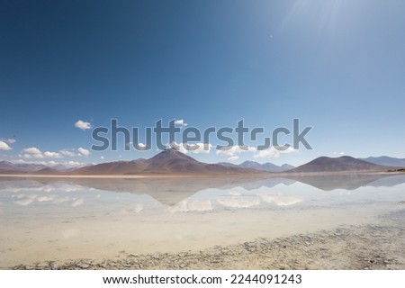 majestic mountain, lake and sky with clouds, beautiful tourist destination in Latin America, wallpaper in the day, quiet place without people, natural condition Royalty-Free Stock Photo #2244091243