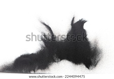 Small size black Sand flying explosion, carbon dust sands grain explode. Abstract cloud fly. Black colored sand splash throwing in Air. White background Isolated high speed shutter, throwing freeze Royalty-Free Stock Photo #2244094475
