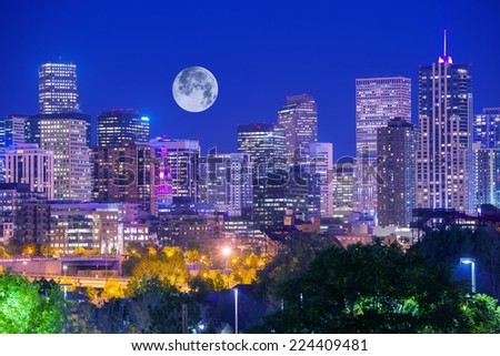 Denver Colorado at Night. Denver Downtown Skyline and the Full Moon on Clear Sky. 