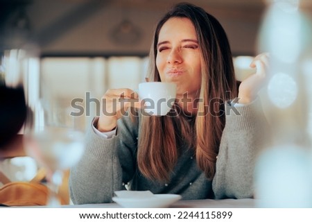 
Displeased Woman Disliking Coffee for Tasting and Smelling Bad
Unhappy customer hating bitter tasting unsweetened decaf beverage
 Royalty-Free Stock Photo #2244115899
