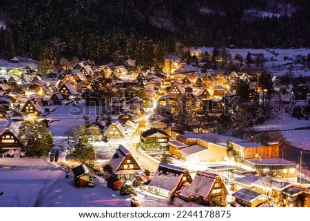 Night view of Shirakawa-go in winter (Gifu, Japan). A village registered as a World Heritage site, where the original Japanese landscape still remains. Royalty-Free Stock Photo #2244178875