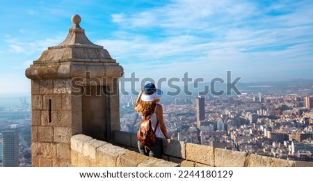 Traveler woman looking at panoramic spanish city landscape from Santa Barbara castle- Alicante
