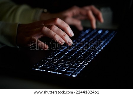 Hands of anonymous person typing on laptop keyboard at night, close up. Cyber security concept Royalty-Free Stock Photo #2244182461