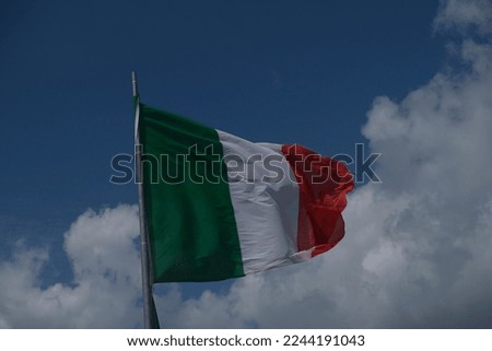 Italian tricolor flag waving in the wind in sunny day. High quality photo