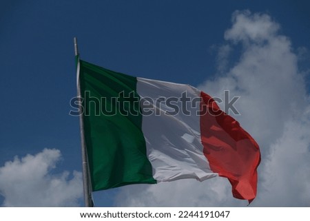 Italian tricolor flag waving in the wind in sunny day. High quality photo