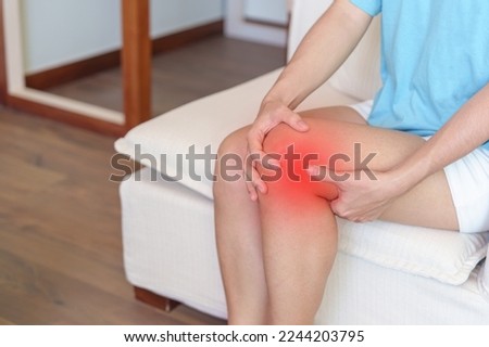 woman having knee ache and muscle pain due to Runners Knee or Patellofemoral Pain Syndrome, osteoarthritis, arthritis, rheumatism and Patellar Tendinitis. medical concept Royalty-Free Stock Photo #2244203795