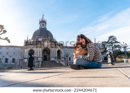 A mother and her son sitting in the Sanctuary of Loyola, Baroque church of Azpeitia, Gipuzkoa, shrine Royalty-Free Stock Photo #2244204671