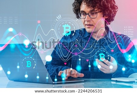 Smiling businessman portrait using laptop and smartphone. Cryptocurrency analysis and falling and rising lines, double exposure. Concept of internet banking and bitcoin