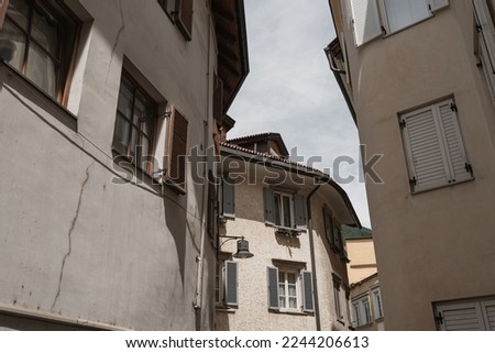 Old historic architecture in Italy. Traditional European old town building. Wooden windows, shutters and colourful pastel walls with sunlight shadows. Aesthetic summer vacation travel background