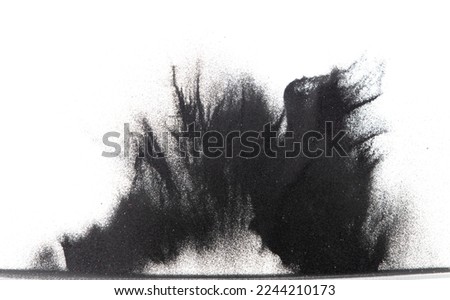 Small size black Sand flying explosion, carbon dust sands grain explode. Abstract cloud fly. Black colored sand splash throwing in Air. White background Isolated high speed shutter, throwing freeze Royalty-Free Stock Photo #2244210173