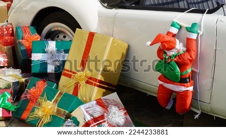 Toy Santa, Gift Boxes and a vintage car. New Year's concept