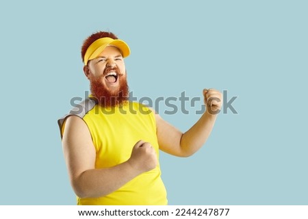 Happy guy having fun at sports workout. Funny athlete celebrating victory. Fat man in yellow sportswear fist pumping and shouting Yes, Yeah, I did it. Crazy coach supporting his team. Success concept