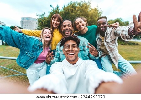 Multiracial group of friends taking selfie picture walking on city street - Happy young people smiling together at camera outside - University students having fun in college campus - Youth culture Royalty-Free Stock Photo #2244263079