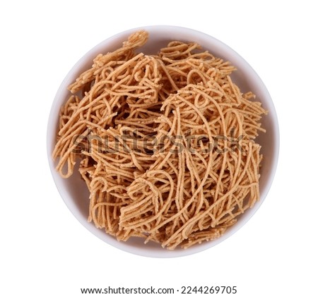 On a white backdrop, a bowl of quick noodles is shown in the concept of delicious, uncooked eating.