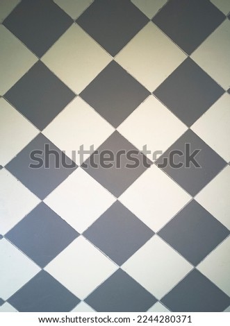 Gray concentric rhombuses. abstract geometric seamless textured pattern. marble texture, rhythmic calm pattern in the base color. Medium gray and white diagonal checkers on a textured tile background