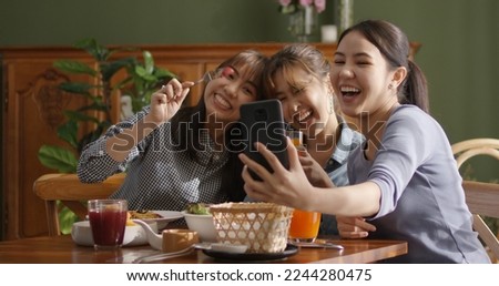 Small girl group party asia people busy talk smile eat brunch food drink. Young woman fun happy hour meal shoot photo of dish plate salad bowl on table post ig reel story app in vegan cafe bar shop. Royalty-Free Stock Photo #2244280475
