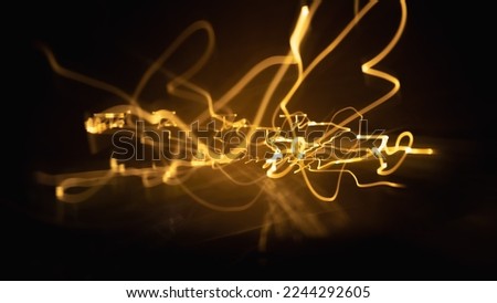 Long exposure light painting photography, curvy lines of vibrant neon different color against a black background.Bright neon line designed background.Modern background in lines style.Abstract,creative Royalty-Free Stock Photo #2244292605