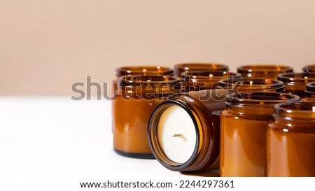 Group of Handmade Soy and coconut wax candles in a Amber and opaque container, brown glass jar. Natural eco friendly organic candles. Concept sustainability and vegan plastic free product. Copy space Royalty-Free Stock Photo #2244297361