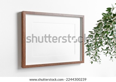 Blank frame mockup on white wall for artwork, photo, painting or print presentation