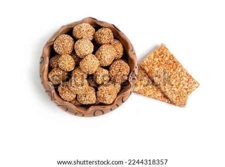 Indian sweet for traditional festival makar sankranti , Rajgira laddu made from Amaranth seed in Bowl on Brown background Royalty-Free Stock Photo #2244318357