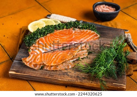 Scandinavian Gravlax Salmon fillet with dill, salt and papper. Orange background. Top view