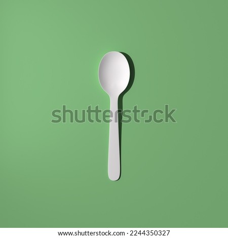 White spoon on a green background, 3d render, 3d illustration