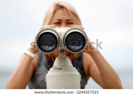 Woman using panoramic binoculars.  Piran. Slovenia.  Royalty-Free Stock Photo #2244357221