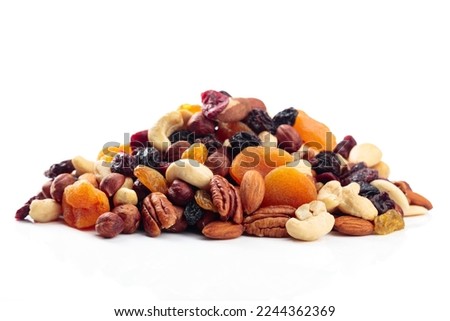 Mix of nuts and dried fruits isolated on a white background. Presented apricots, raisins, walnuts, hazelnuts, cashews, pecans, and almonds. Royalty-Free Stock Photo #2244362369