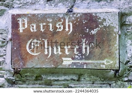 Stone carved Parish Church sign on a slate wall