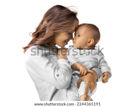 Close-up portrait of a happy mom holds her baby in her arms. Isolated on white.