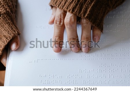Annual  celebration of World Braille Day (January 4). Hand of a blind person reading some braille text touching the relief. Empty copy space for Editor's content. Close-up of fingers reading braille,