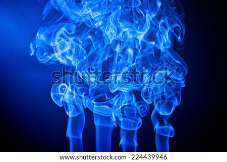 Artistic blue smoke on black background texture.